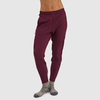 Women's burgundy fleece pants with elastic waistband and cuffs, worn with gray socks