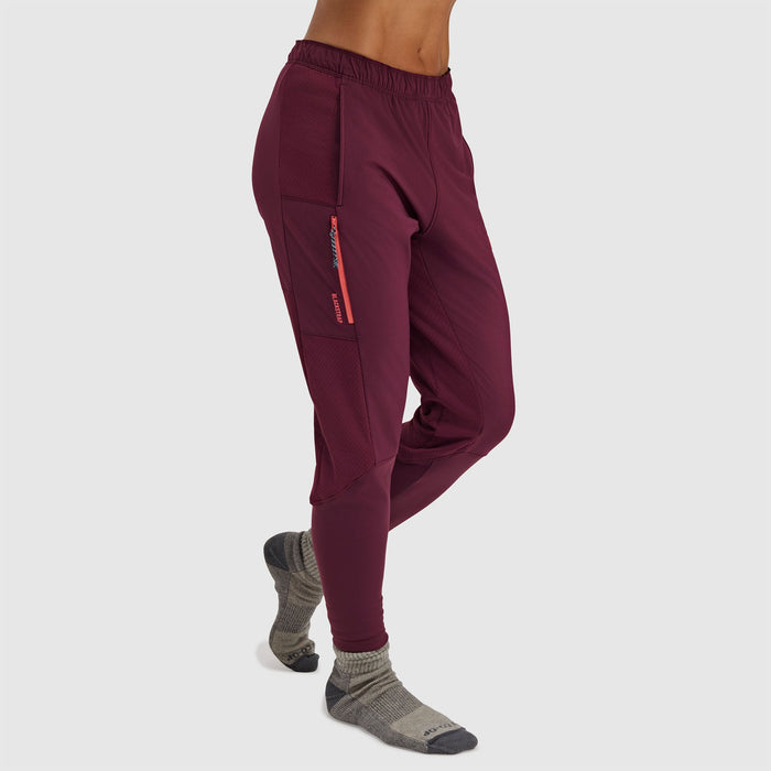 Burgundy fleece pants with zippered side pocket and elastic waistband, side view