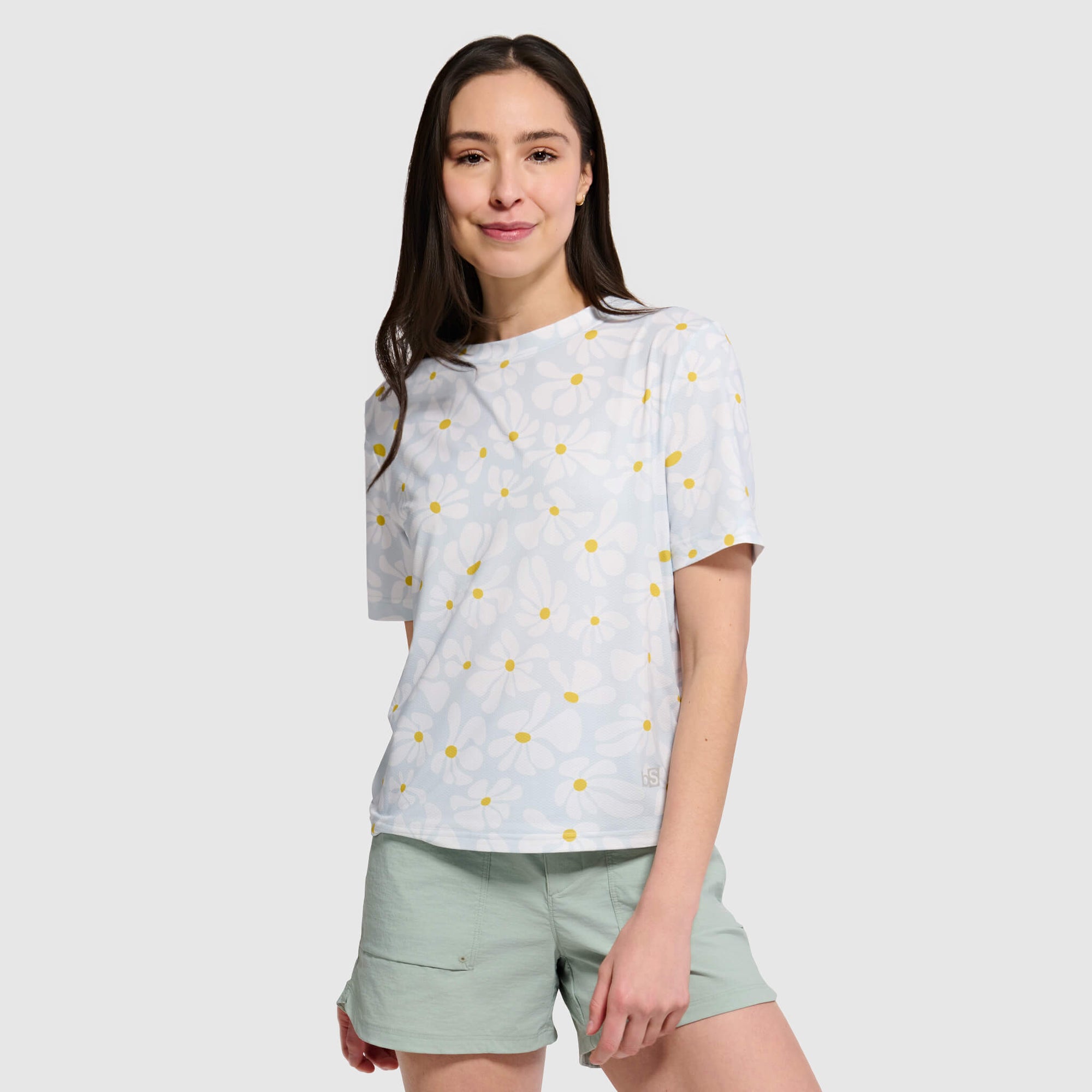 Light blue short-sleeve t-shirt with yellow polka dot pattern worn by woman