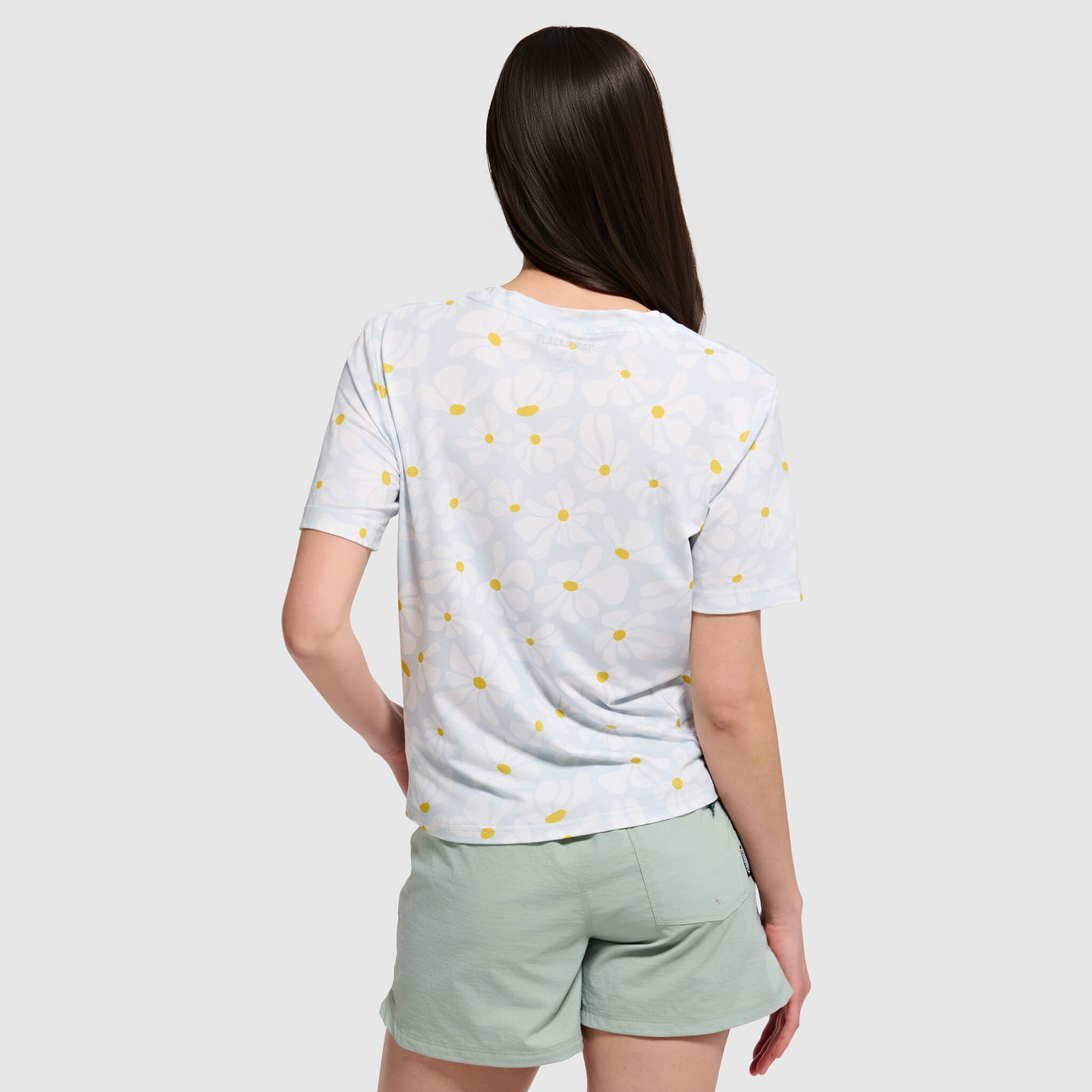 Light blue polka dot t-shirt with yellow dots shown from back view on model