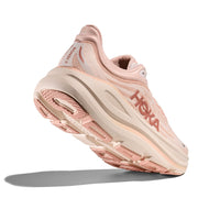 Light pink running shoe with mesh upper and thick cushioned sole, angled side view