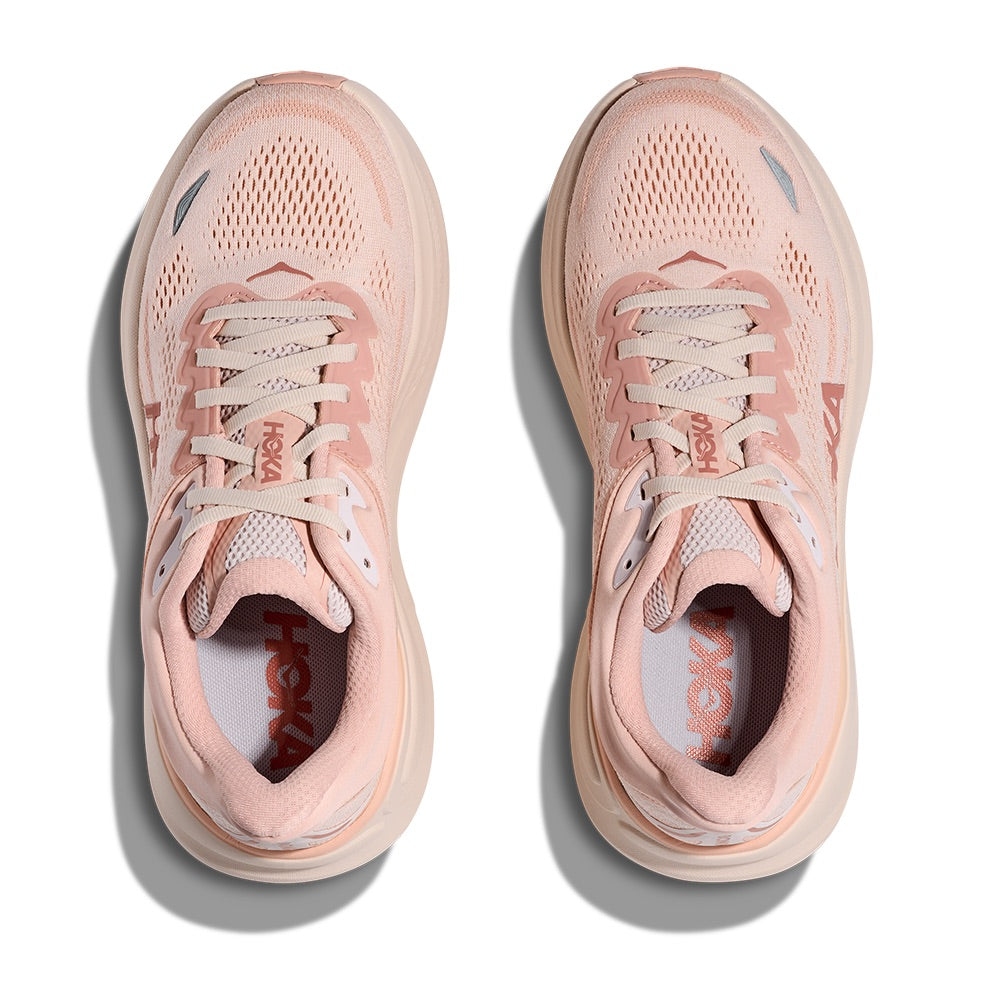Light pink athletic running shoes with mesh upper and lace-up closure, top-down view