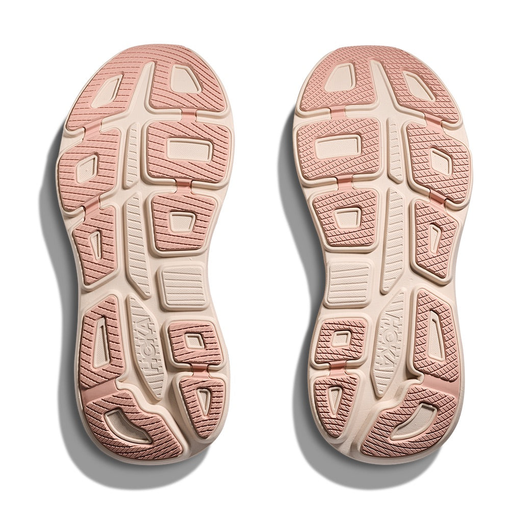 Pink and cream athletic shoe soles showing textured tread pattern and grip zones