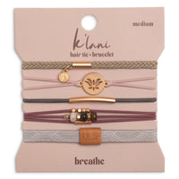 Set of five hair tie bracelets with lotus charm, beads, and leather tab on packaging card