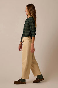 Women's wide-leg barrel fit pants in light tan, side view, worn with plaid shirt