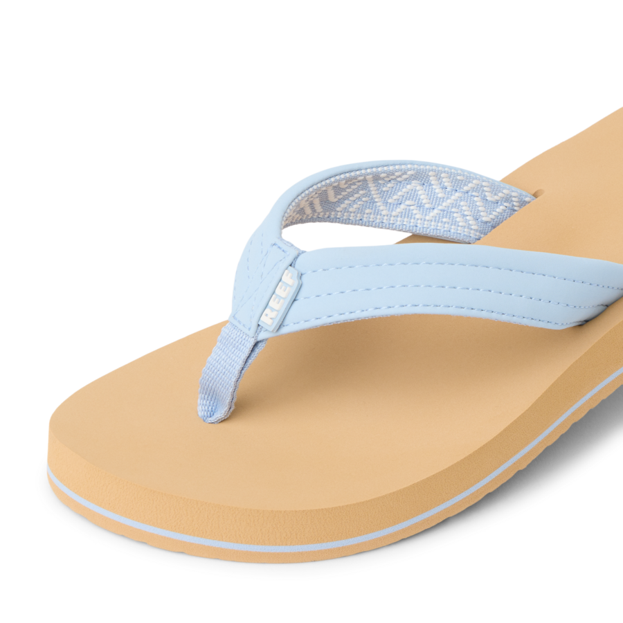 Light blue flip-flop sandal with cushioned sole and patterned strap detail, angled view