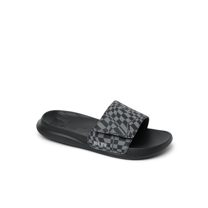 Black slide sandal with checkered pattern strap, side angle view on white background