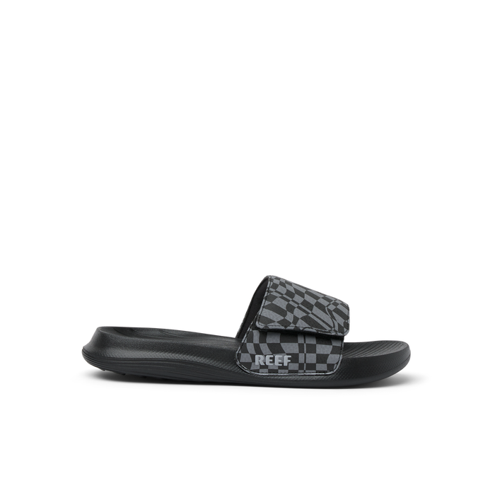 Black slide sandal with gray checkered pattern strap, side profile view