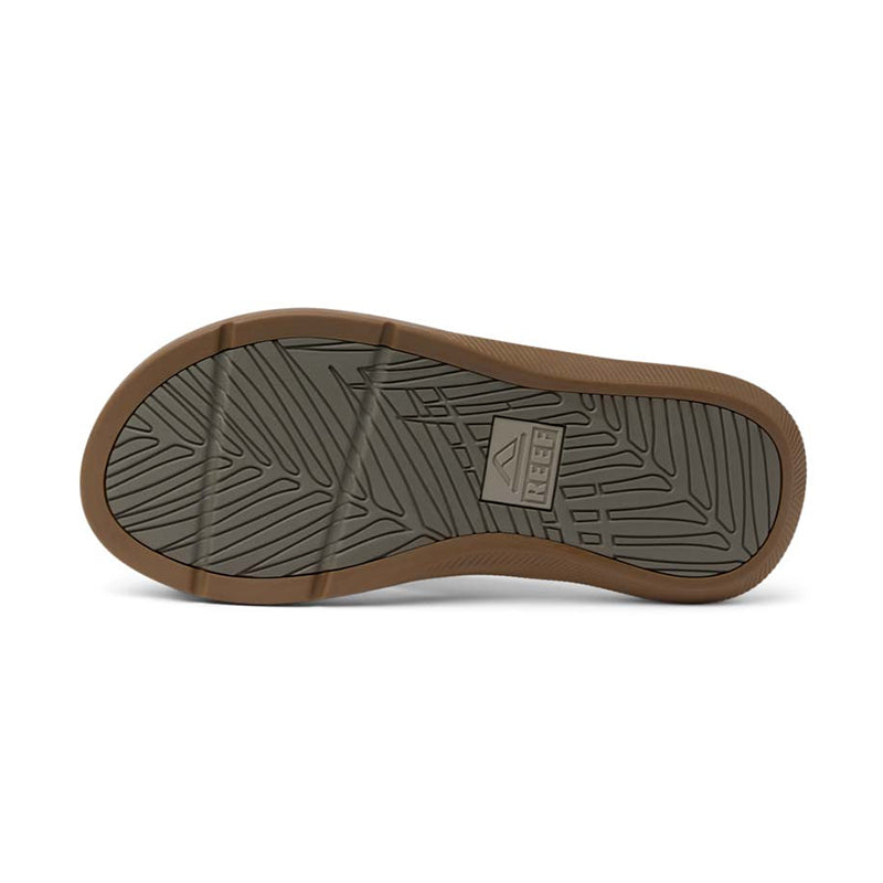 Bottom view of brown leather sandal showing gray sole with geometric tread pattern