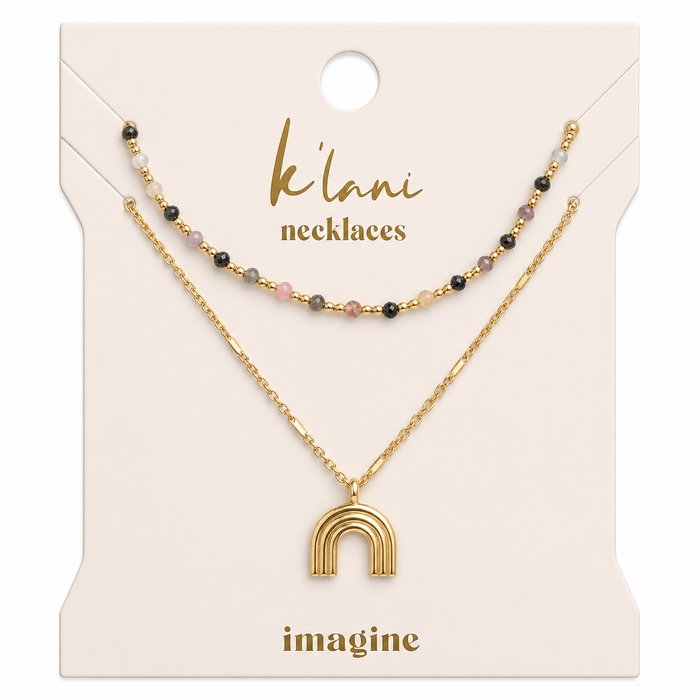 Two-piece necklace set with multicolor beaded strand and gold rainbow arch pendant on display card