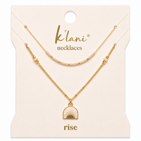Two-piece layered necklace set with beaded strand and gold sunrise charm pendant on display card