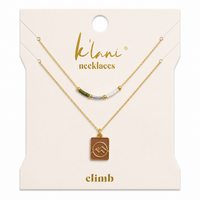 Two-piece necklace set with beaded chain and gold mountain peak pendant on card packaging