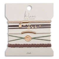 Set of five hair tie bracelets in earth tones with gold-tone accents and mountain medallion charm