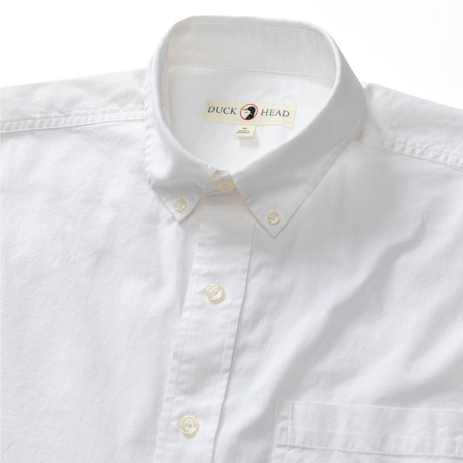 White long sleeve button-down shirt with button-down collar, front view detail