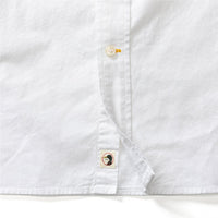 White long sleeve oxford shirt detail showing button placket and brand label