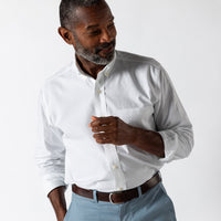 White long-sleeve oxford dress shirt with button-down collar and chest pocket on male model