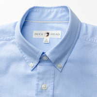 Light blue long sleeve button-down shirt with collar and chest pocket detail