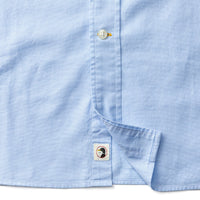 Light blue long sleeve cotton oxford shirt showing button placket and chest pocket detail