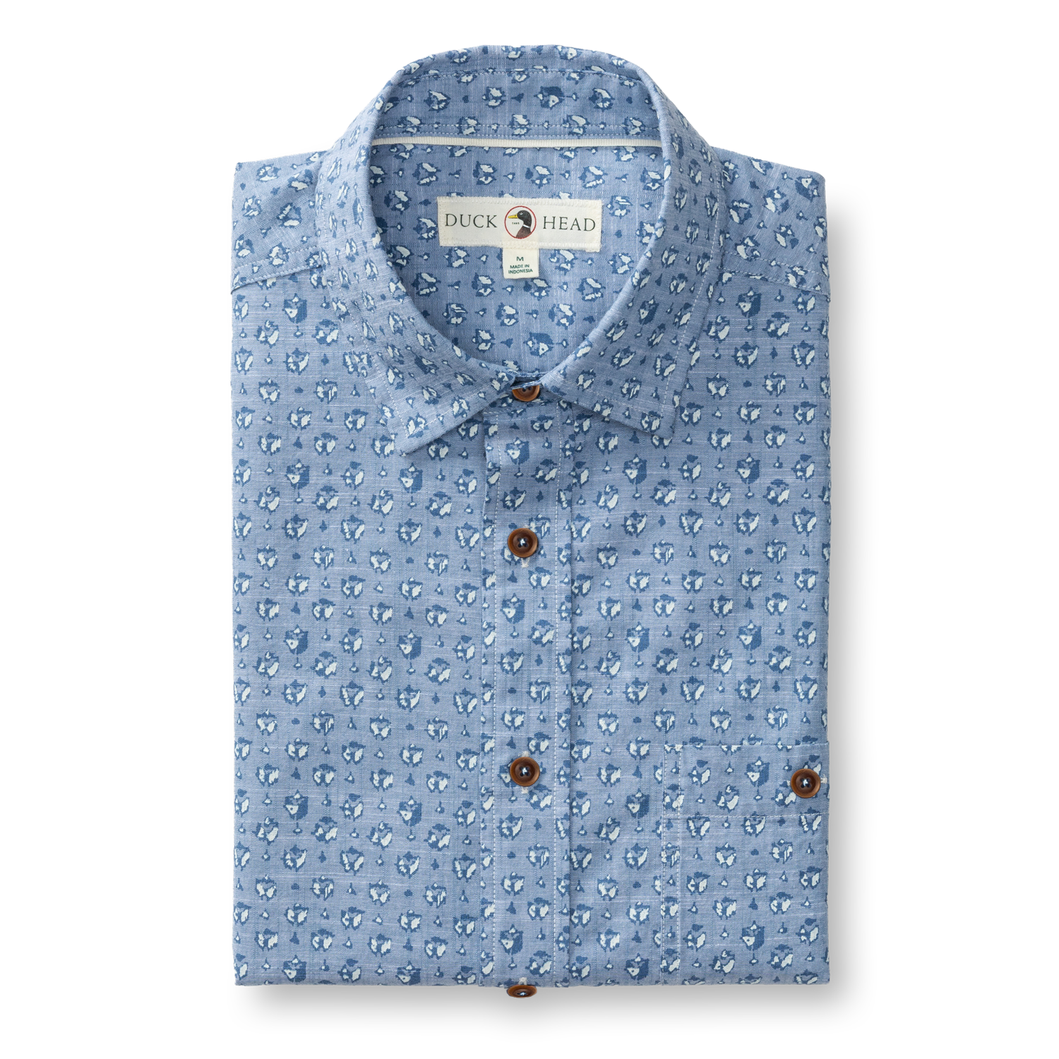 Light blue chambray short sleeve shirt with small repeating pattern and brown buttons