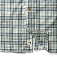Close-up detail of plaid button-down shirt showing chest pocket and Duck Head logo patch