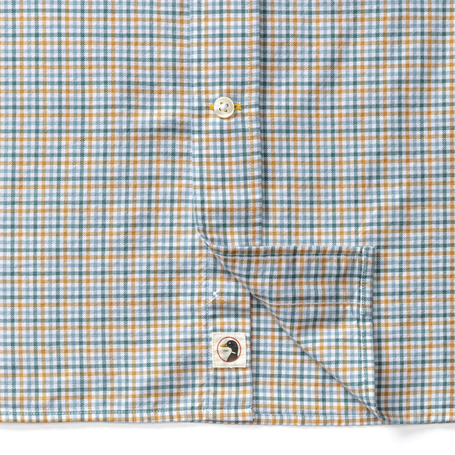 Close-up detail of plaid check shirt showing button placket and Duck Head logo label