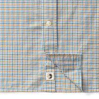 Close-up detail of plaid check shirt showing button placket and Duck Head logo label