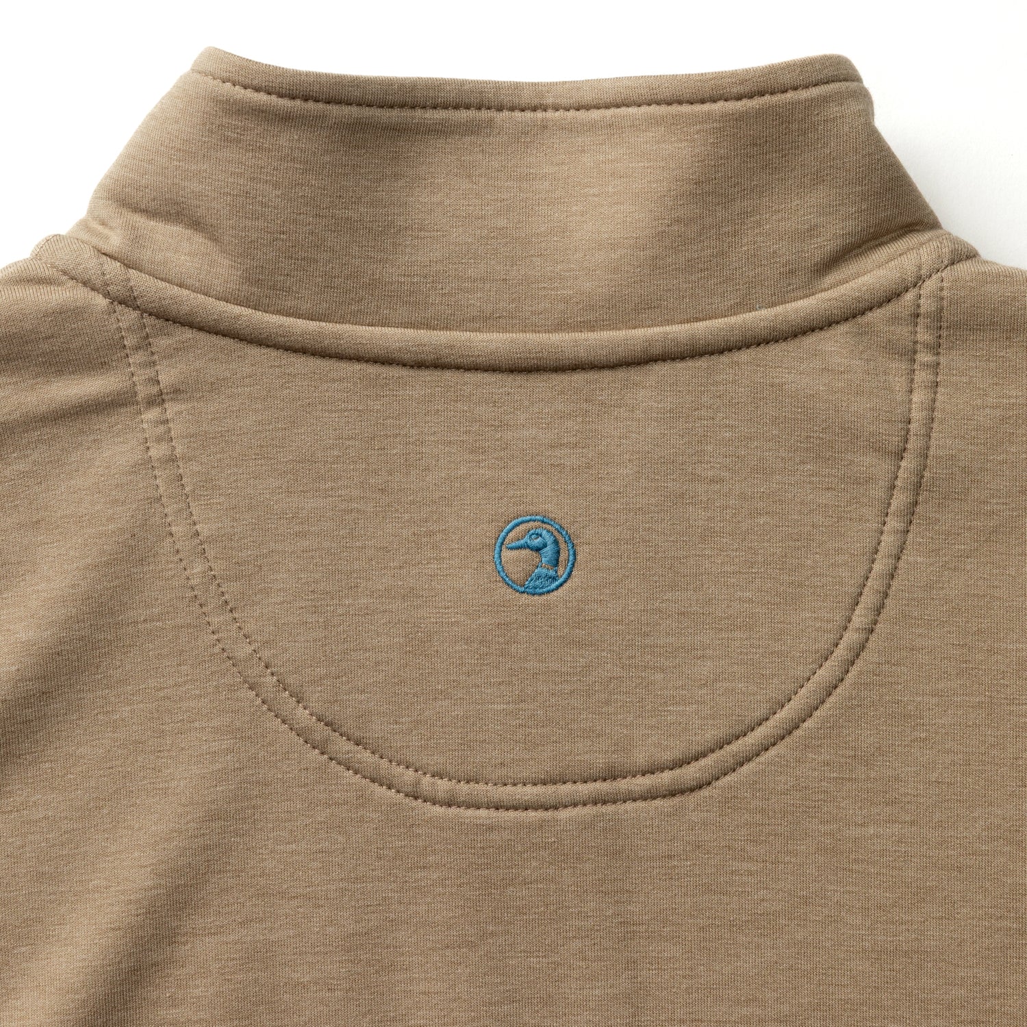 Tan quarter-zip pullover with embroidered logo detail on chest, close-up view