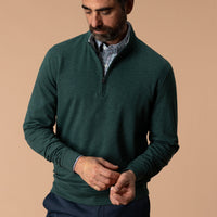 Men's dark green quarter-zip pullover layered over plaid shirt, front on-model view