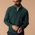 Men's dark green quarter-zip pullover layered over plaid shirt, front on-model view