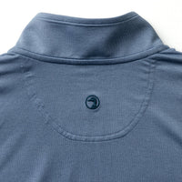 Blue-gray quarter zip pullover detail showing collar, zipper and back yoke construction