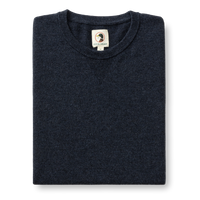 Folded dark navy merino wool crewneck sweater with ribbed collar, front view