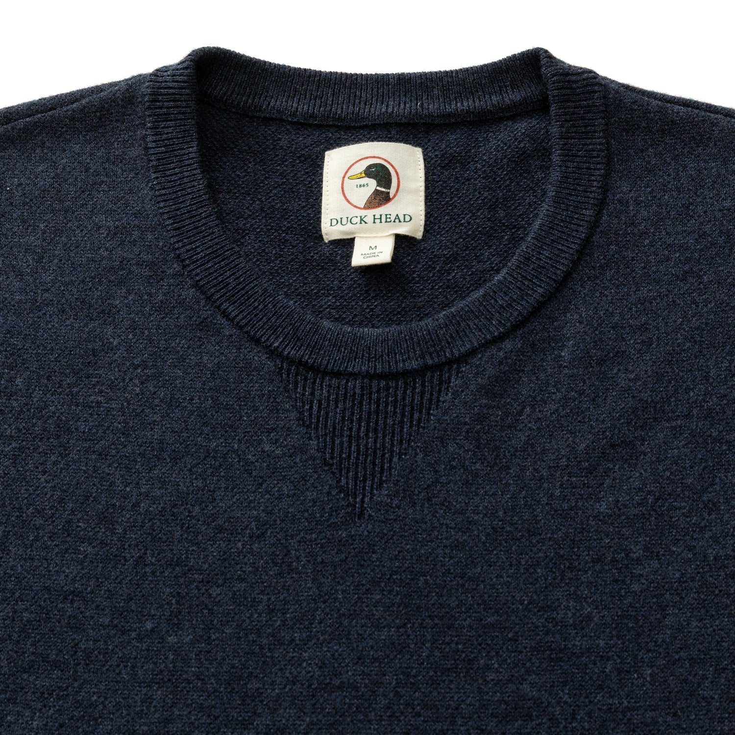 Dark navy heathered merino crewneck sweater, close-up of collar and label detail
