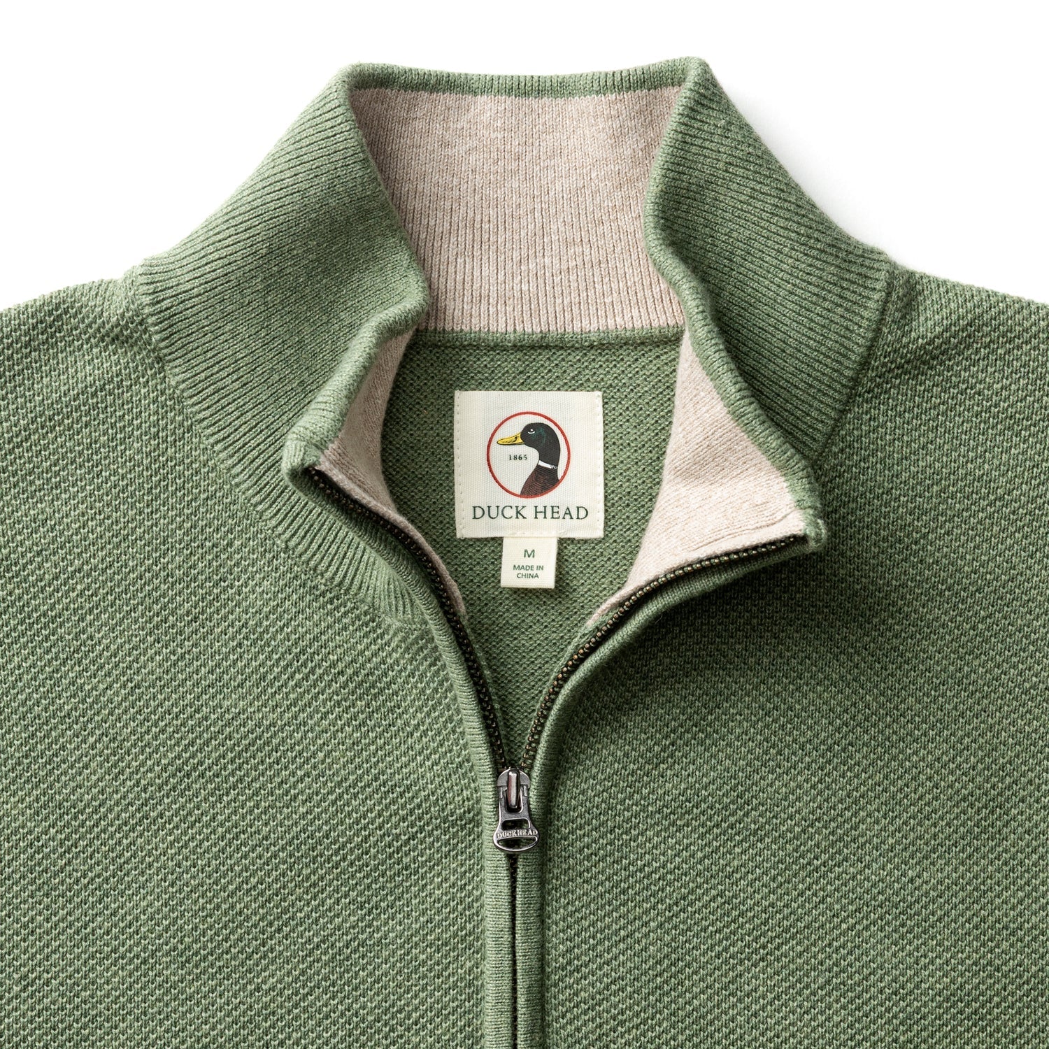 Sage green quarter-zip sweater with ribbed collar and textured knit fabric, front view