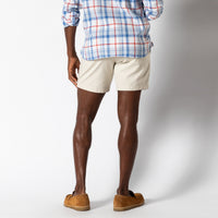 Light beige chino shorts worn with brown suede loafers, back view showing fit and length
