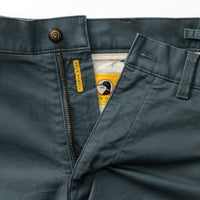 Close-up view of chino shorts waistband and front pocket with zipper detail