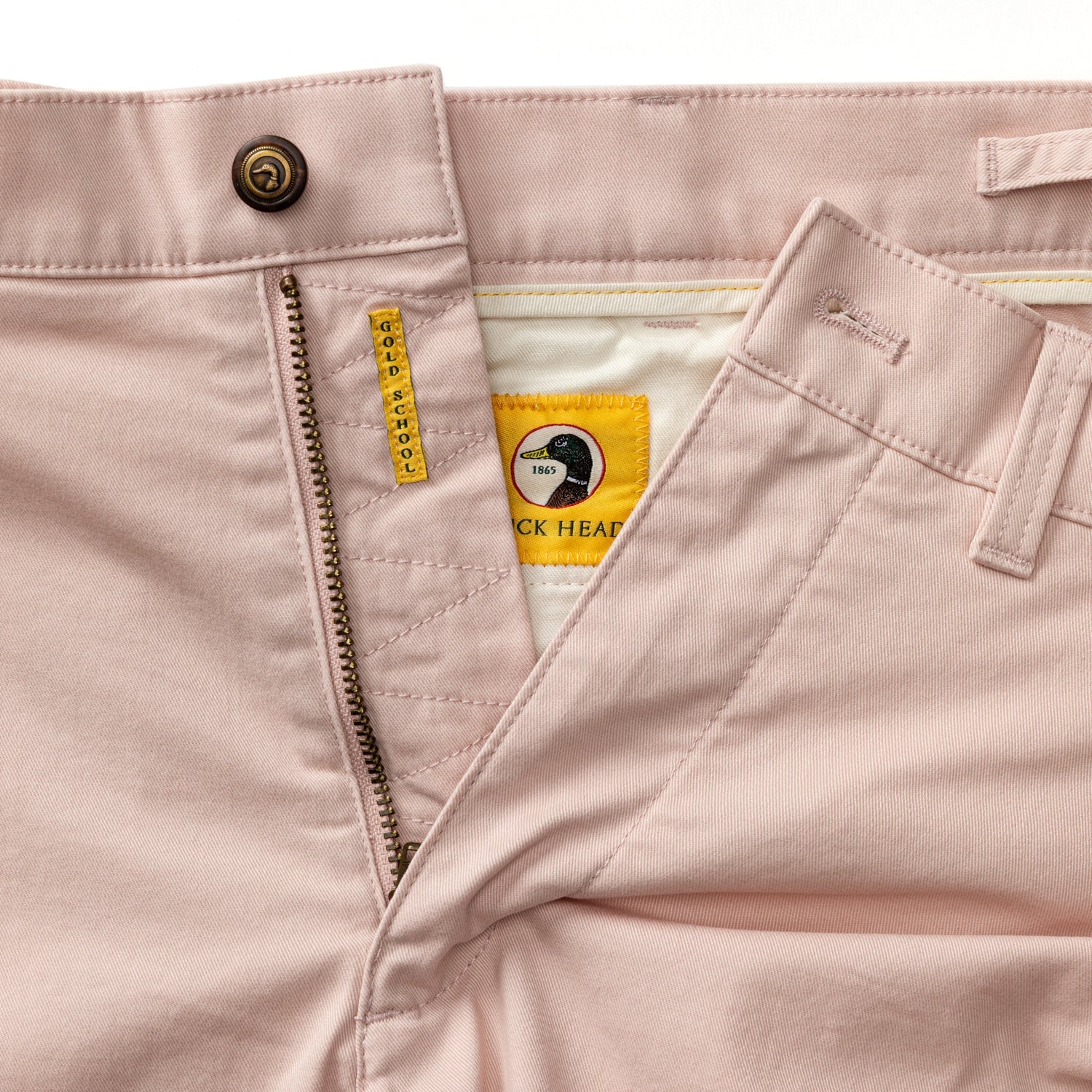 Light pink chino shorts with open fly showing waistband button and pocket details