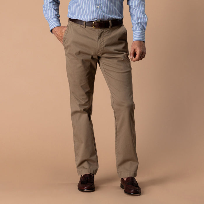 Men's classic fit tan chino pants with brown leather belt, front on-model view