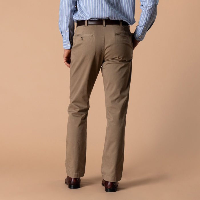 Men's classic fit chino pants in tan, back view, with belt and leather shoes