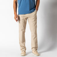 Light beige chino pants on male model with blue shirt, front view studio photo