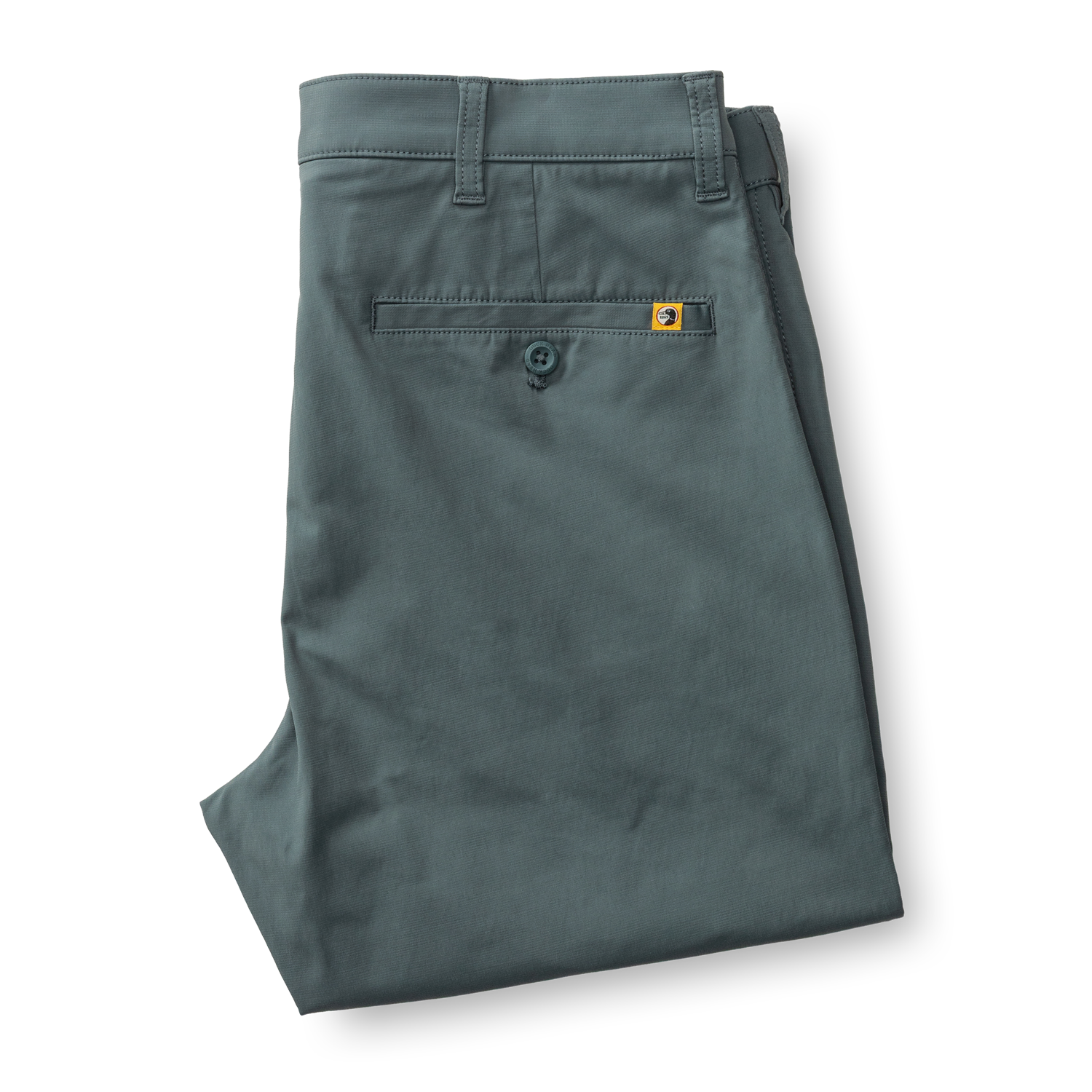 Sage green chino pants folded to show back pocket details and construction