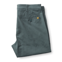 Sage green chino pants folded to show back pocket details and construction