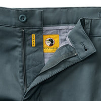 Men's chino pants waistband and fly detail showing button closure and brand label