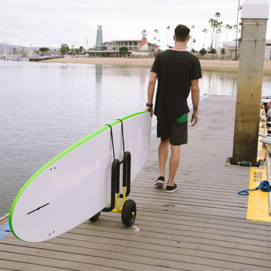 White SUP cart with wheels and handle pulling paddleboard on wooden dock