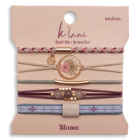 Set of five hair tie bracelets with floral medallion, braided, beaded, and patterned elastic styles on packaging card