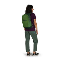 On-body back view of a green daypack with padded straps and multiple compartments