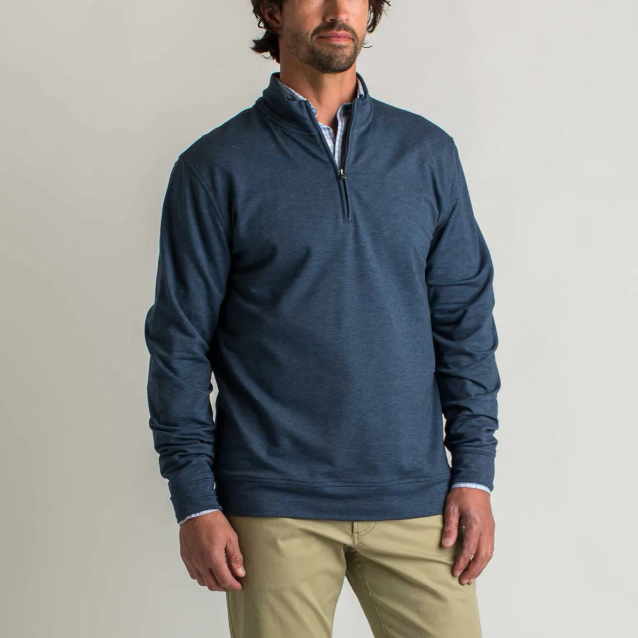 Navy blue quarter-zip pullover sweatshirt worn by male model, front view