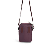 Small burgundy crossbody bag with adjustable strap and zippered compartment, studio shot