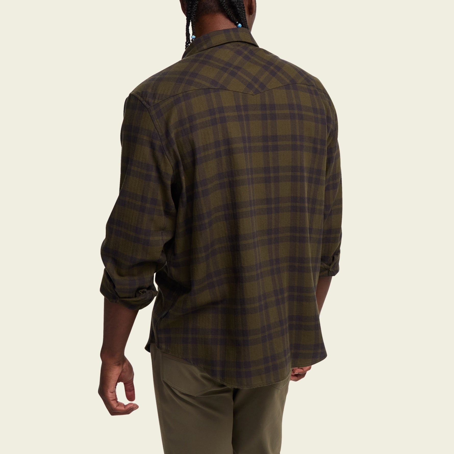 Men's plaid flannel shirt back view, dark olive tartan pattern, long sleeves rolled at cuffs