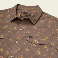 Men's western snap shirt in floral print with pearl snaps and dual chest pockets, angled flat lay