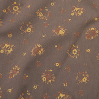 Close-up detail of floral print fabric with small bouquet clusters on taupe brown background